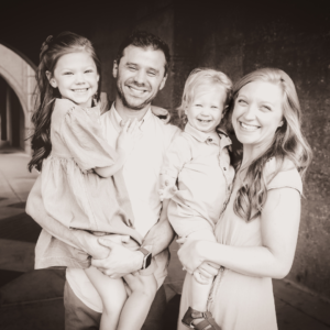 Black and White family picture outside under a bridge